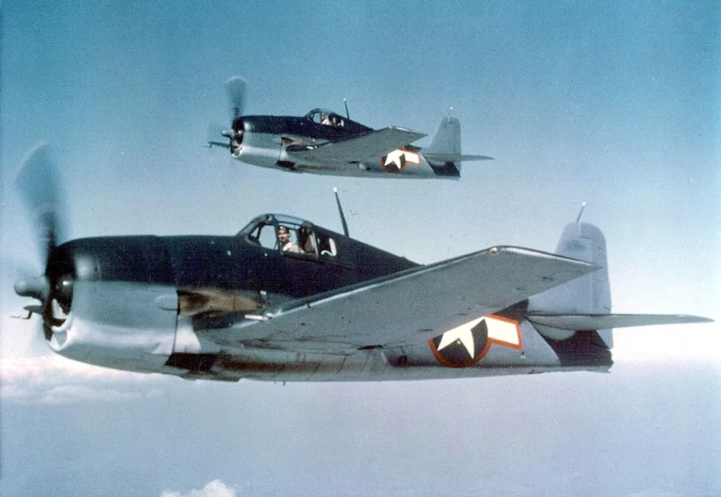 Two Grumman F6F Hellcat fliying high pilot giving a pose