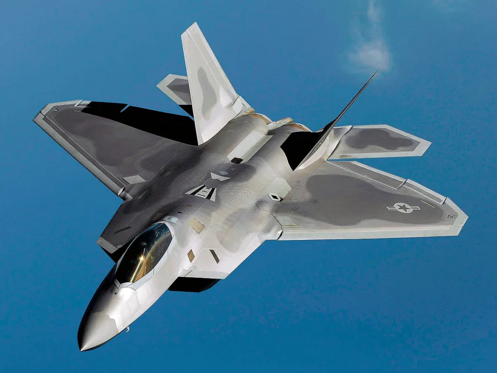 Lockheed Martin F-22 Raptor in flight blue sky background