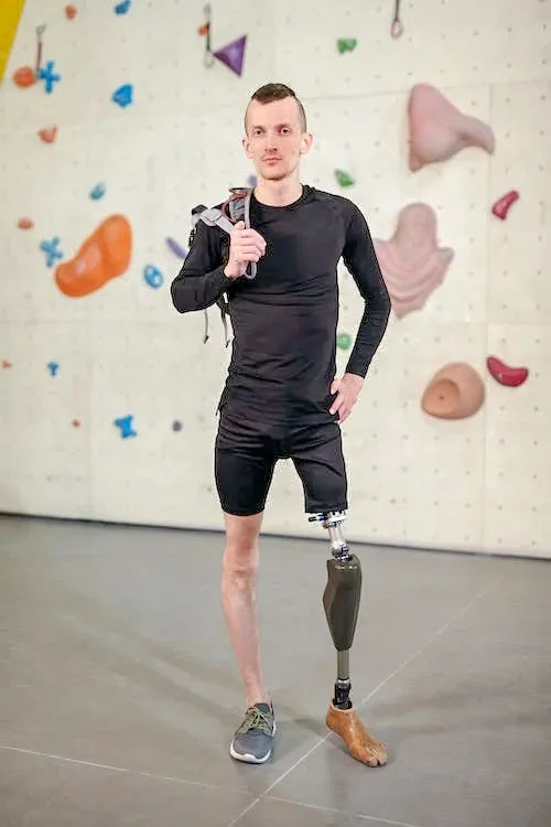slim man with left artificial leg standing