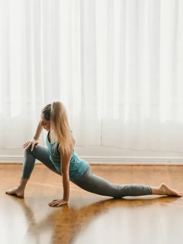 woman stretching legs with one hand on thigh and other on ground facing left