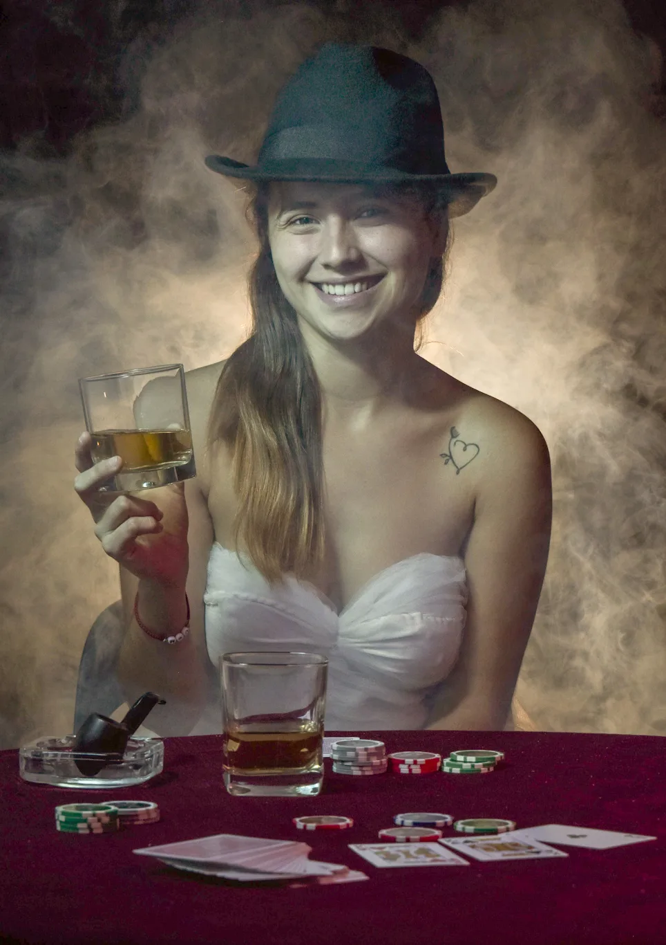 photo-of-a-woman-in-white-tube-top-smiling-while-holding-a-drinking-glass- Guide to Poker