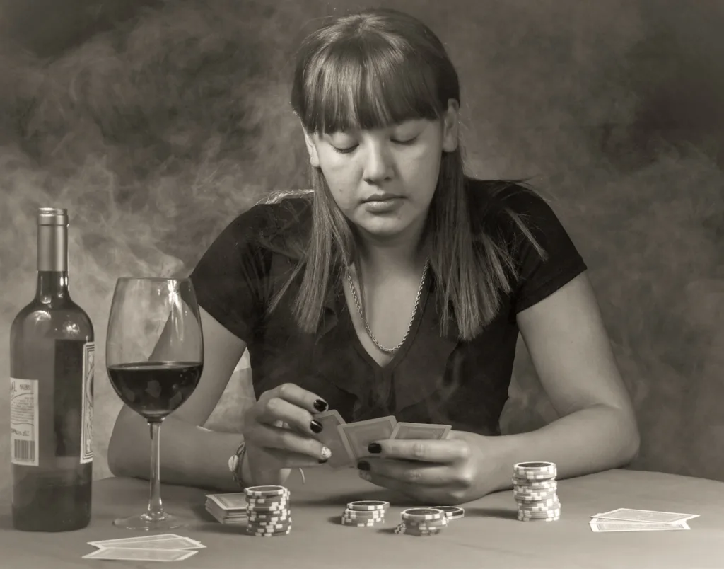 photo-of-woman-playing-a-card-game-and-drinking-wine