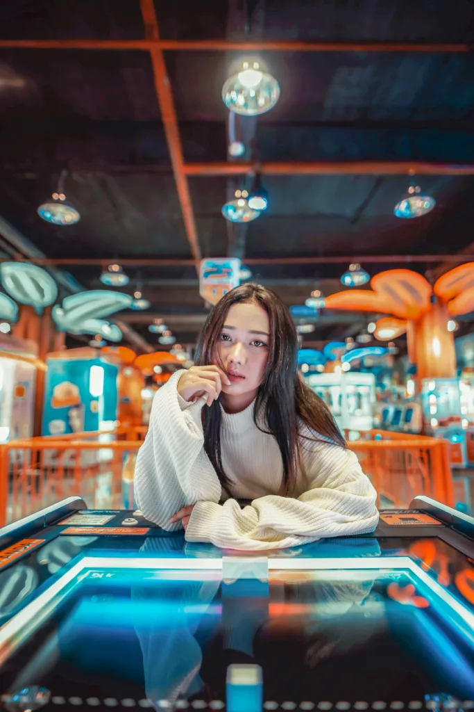woman sitting inside a casino in white full sleeves top