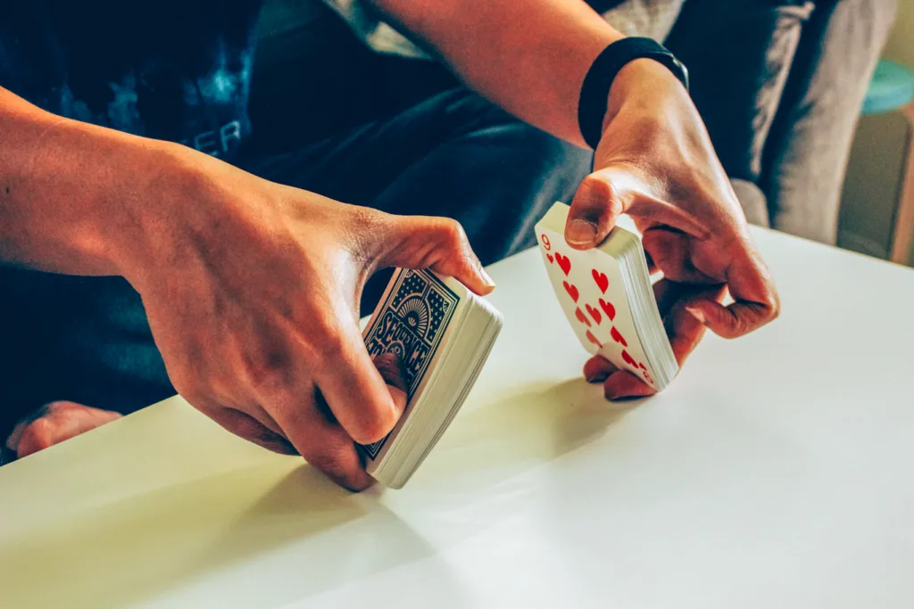 person shuffling cards on a table
