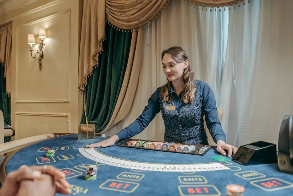 woman working in a casino laid the playing cards on the wide table-Casino Careers
