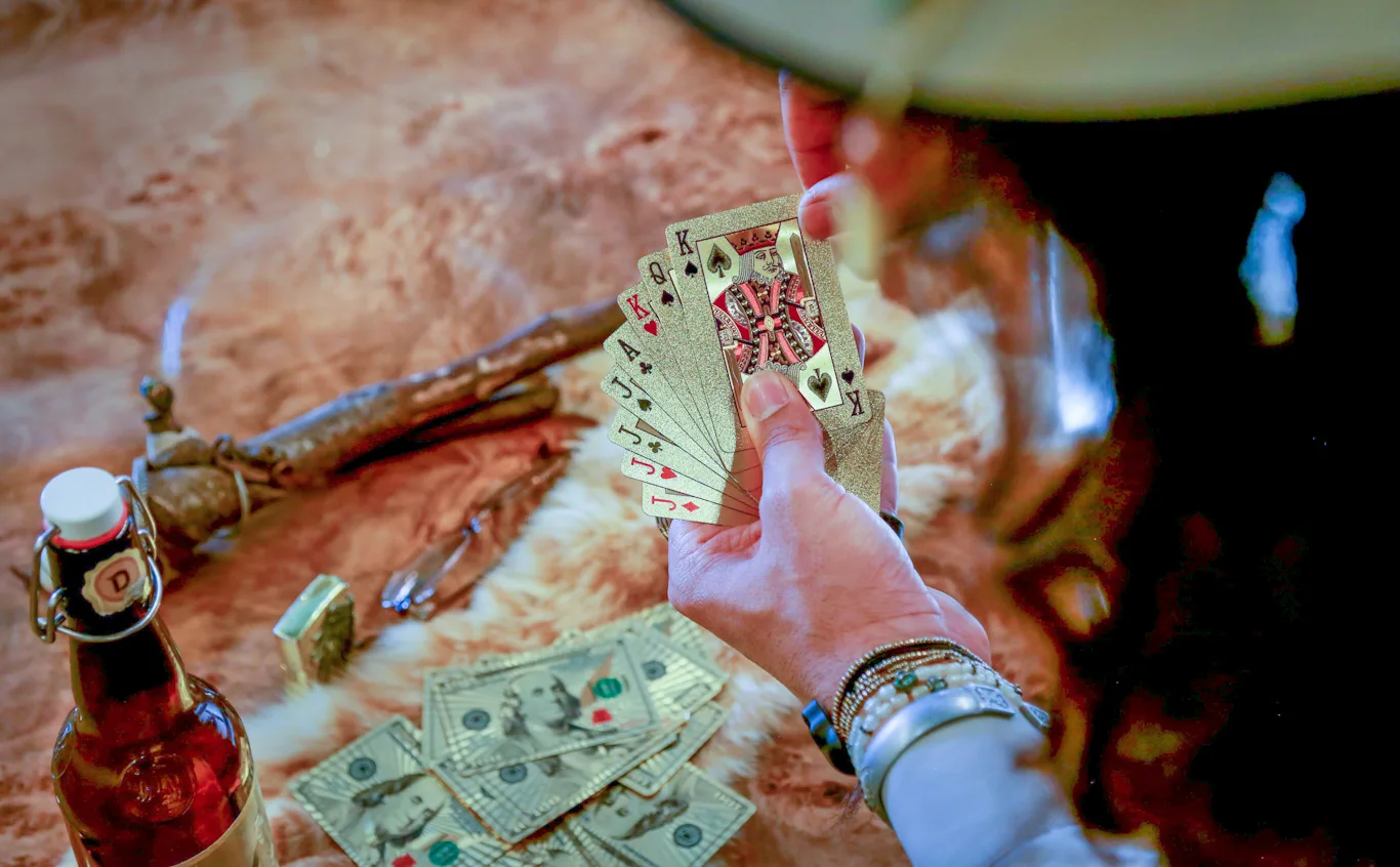 person holding cards in hand king of spades-Casino Industry Trends