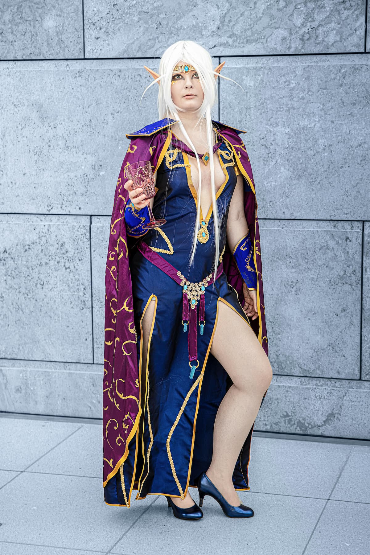 woman with blue elf costume with thigh slit gown on both legs for cosplay having white hair