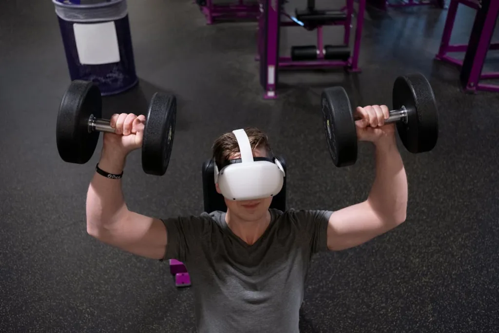Man with VR box lifting two weights during exercise