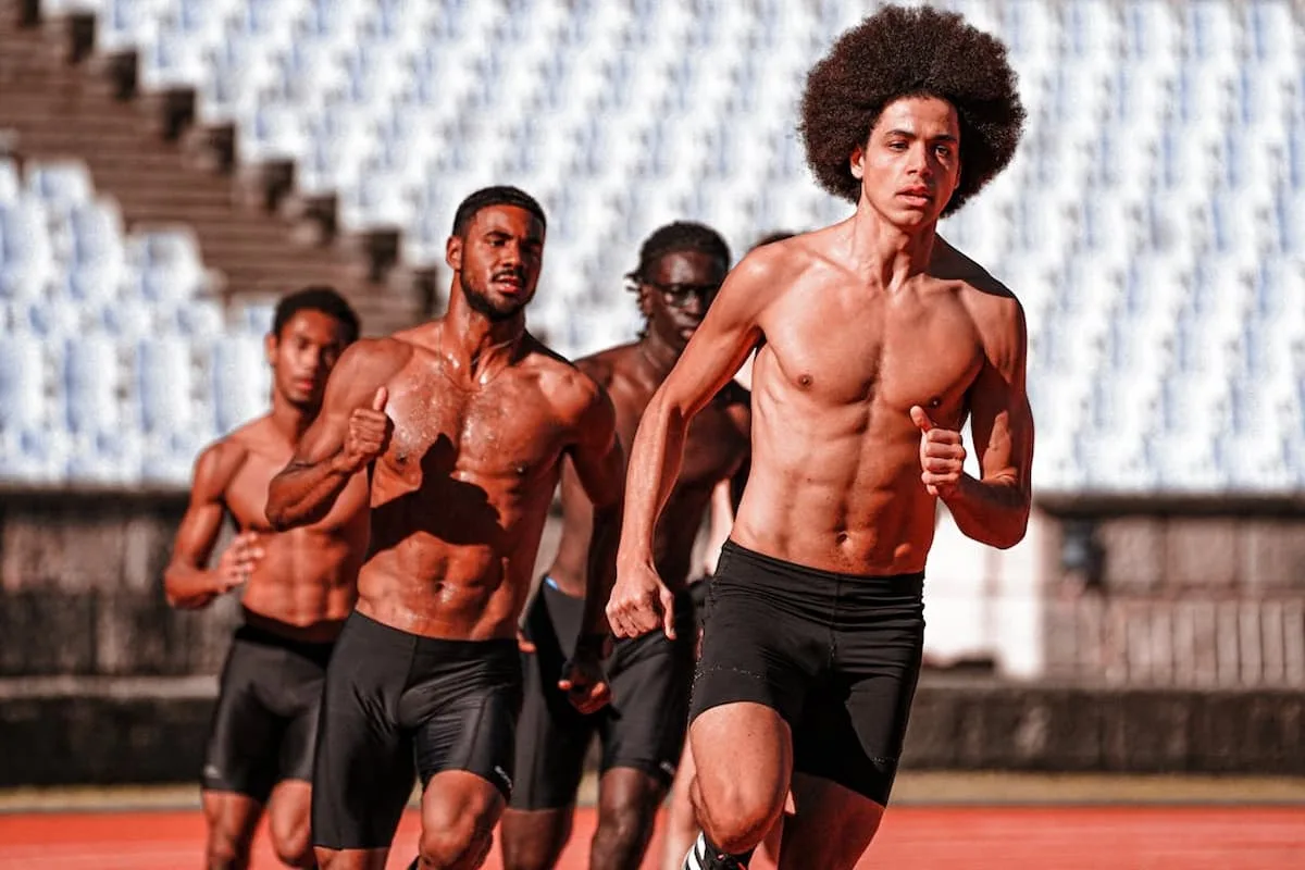 group of shirtless men running inside a field - Techniques and Training in American Football