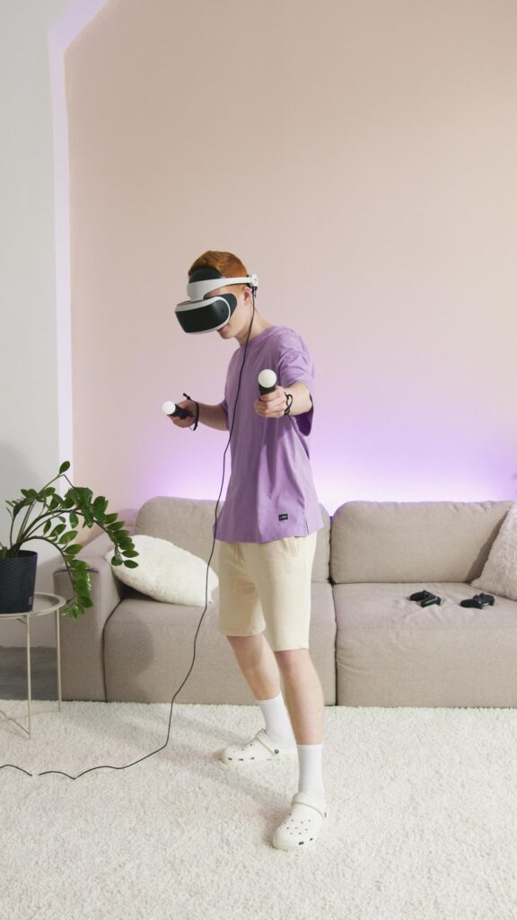 a boy wearing eye gear and holding VR gear playing