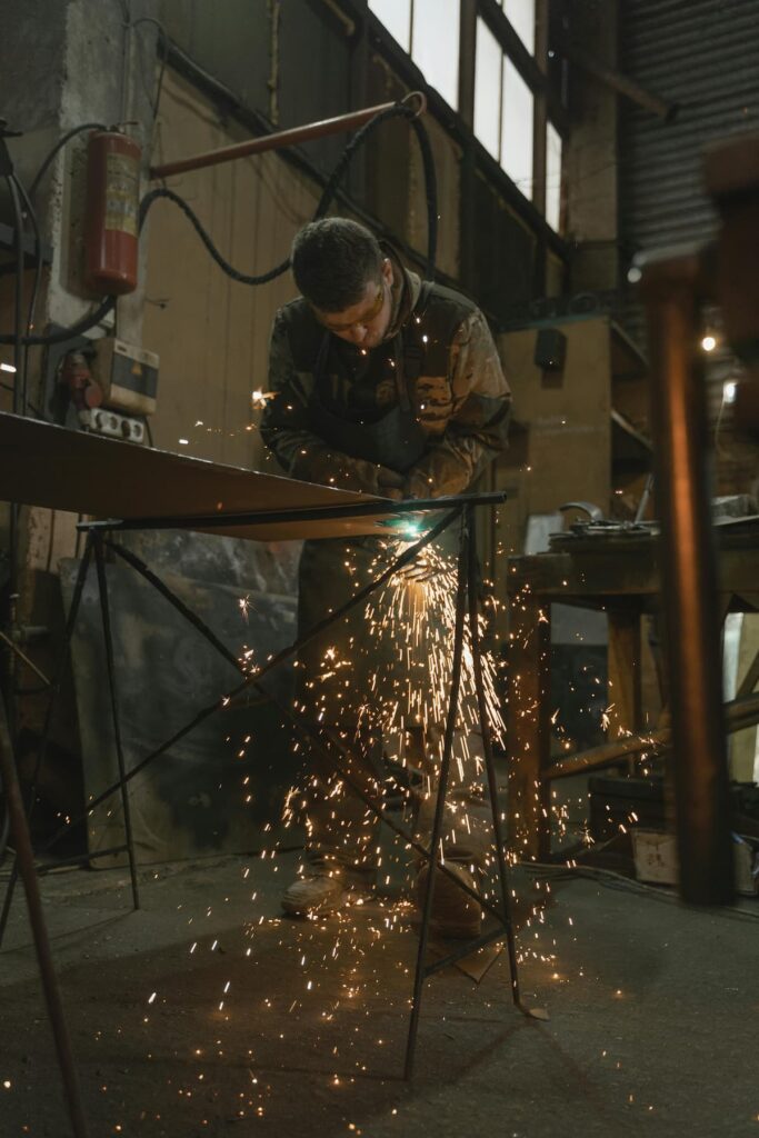man with eye glasses welding/cutting